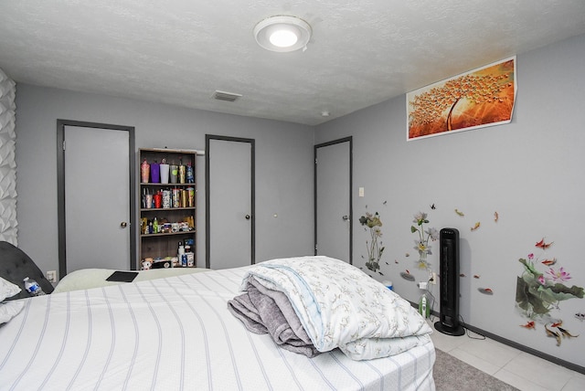 12469 Sharpview Dr Unit 2469, Houston, TX 77072 - bedroom featuring light tile patterned floors