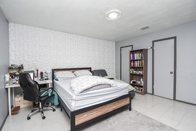12469 Sharpview Dr Unit 2469, Houston, TX 77072 - tiled bedroom with wallpapered walls, an office area, and an accent wall