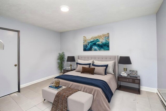 12469 Sharpview Dr Unit 2469, Houston, TX 77072 - bedroom featuring baseboard heating and light tile patterned floors