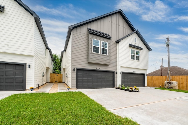8122 Corinth St, Houston, TX 77051 - view of front of home with a garage, driveway, and board and batten siding