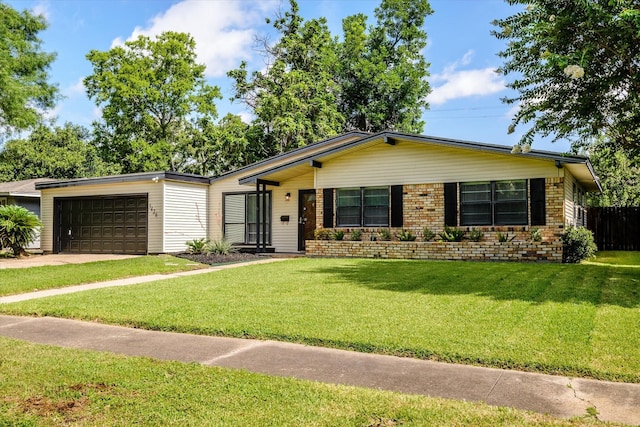 5426 Carew St, Houston, TX 77096 - view of front facade with an attached garage, brick siding, and concrete driveway