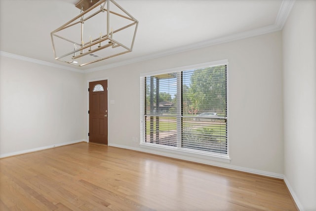 5426 Carew St, Houston, TX 77096 - entryway with ornamental molding, light wood-style floors, and a chandelier