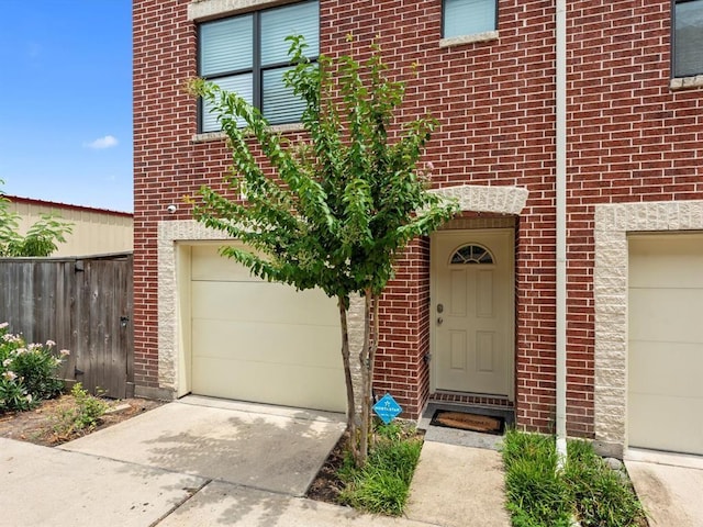 2710 Hullsmith Dr Unit 1004, Houston, TX 77063 - view of front of house featuring concrete driveway, a garage, and brick siding