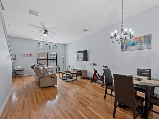 2710 Hullsmith Dr Unit 1004, Houston, TX 77063 - dining space featuring light wood finished floors, a chandelier, and a ceiling fan