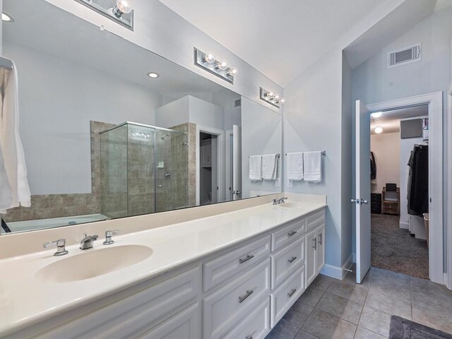 2710 Hullsmith Dr Unit 1004, Houston, TX 77063 - full bath with double vanity, a stall shower, tile patterned floors, a walk in closet, and a bath