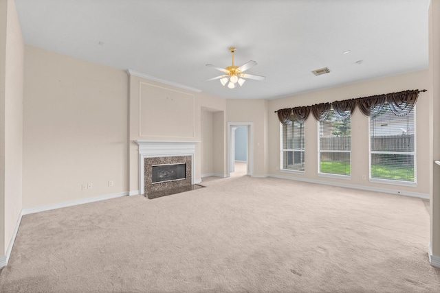 8722 Melting Shadows Ln, Houston, TX 77095 - unfurnished living room featuring light carpet, a high end fireplace, and a ceiling fan