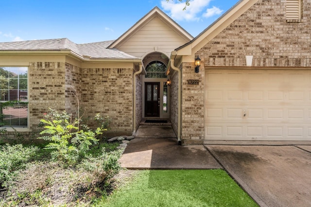 8722 Melting Shadows Ln, Houston, TX 77095 - property entrance featuring brick siding, a garage, driveway, and a shingled roof