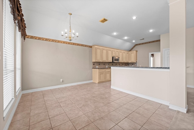 8722 Melting Shadows Ln, Houston, TX 77095 - kitchen featuring stainless steel microwave, lofted ceiling, a chandelier, tasteful backsplash, and light tile patterned floors