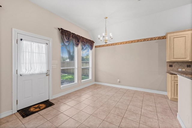 8722 Melting Shadows Ln, Houston, TX 77095 - unfurnished dining area with a chandelier, light tile patterned floors, and lofted ceiling