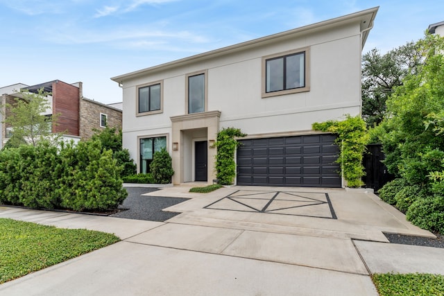 2707 Westgrove Ln, Houston, TX 77027 - contemporary home featuring a garage, stucco siding, and driveway