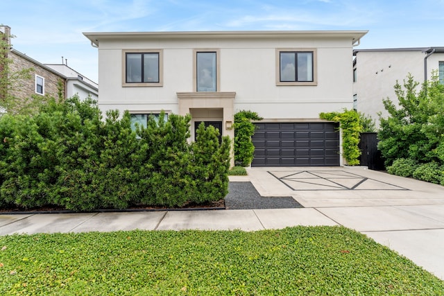 2707 Westgrove Ln, Houston, TX 77027 - view of front facade with stucco siding, an attached garage, and driveway