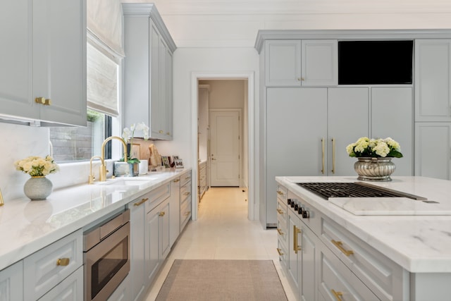 2707 Westgrove Ln, Houston, TX 77027 - kitchen featuring stainless steel microwave, white gas cooktop, and light stone countertops