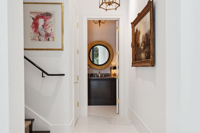 2707 Westgrove Ln, Houston, TX 77027 - hallway featuring a chandelier and baseboards