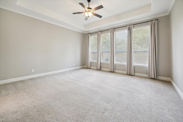 27722 Lakeway Trail Ln, Fulshear, TX 77441 - carpeted spare room featuring a tray ceiling, a ceiling fan, and ornamental molding