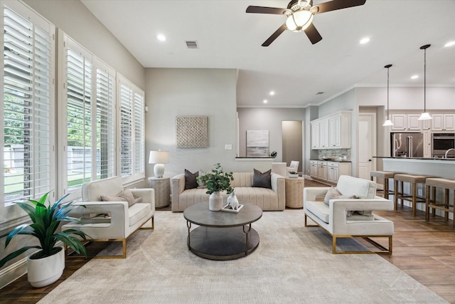 27722 Lakeway Trail Ln, Fulshear, TX 77441 - living room with ceiling fan, light wood-type flooring, ornamental molding, and recessed lighting