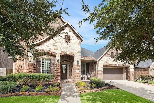 27722 Lakeway Trail Ln, Fulshear, TX 77441 - french country home with stone siding, concrete driveway, a garage, and brick siding