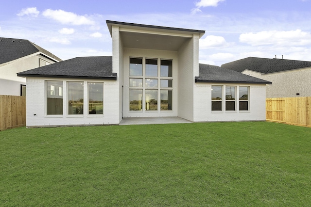 10922 Palmwood Dr, Missouri City, TX 77459 - back of house with brick siding, a shingled roof, a fenced backyard, and a patio