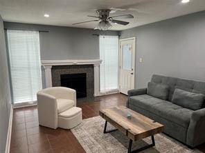 12500 Sandpiper Dr Unit 57, Houston, TX 77035 - living room featuring ceiling fan, tile patterned floors, plenty of natural light, a fireplace, and recessed lighting