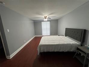 12500 Sandpiper Dr Unit 57, Houston, TX 77035 - bedroom with wood finished floors and a ceiling fan