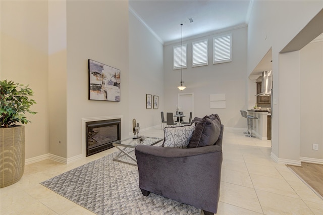 13423 Preston Cliff Ln, Houston, TX 77077 - living room featuring a towering ceiling, crown molding, light tile patterned floors, and a glass covered fireplace
