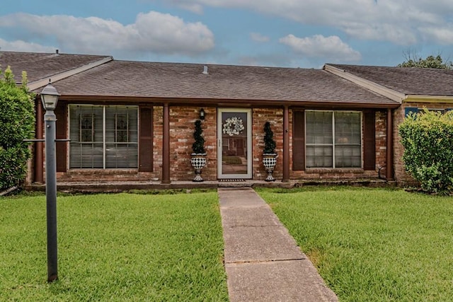 5975 Meadow Way, Beaumont, TX 77707 - ranch-style home featuring a front yard, a shingled roof, and brick siding
