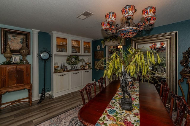 5975 Meadow Way, Beaumont, TX 77707 - dining area with wood finished floors, a chandelier, and a textured ceiling