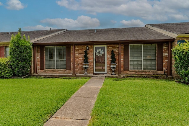 5975 Meadow Way, Beaumont, TX 77707 - single story home with a front yard, roof with shingles, and brick siding