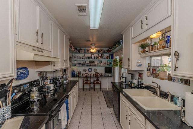 5975 Meadow Way, Beaumont, TX 77707 - kitchen with black appliances, under cabinet range hood, light tile patterned floors, and white cabinets