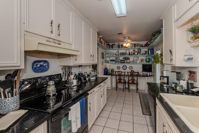 5975 Meadow Way, Beaumont, TX 77707 - kitchen with black range with electric cooktop, under cabinet range hood, white cabinets, and a ceiling fan