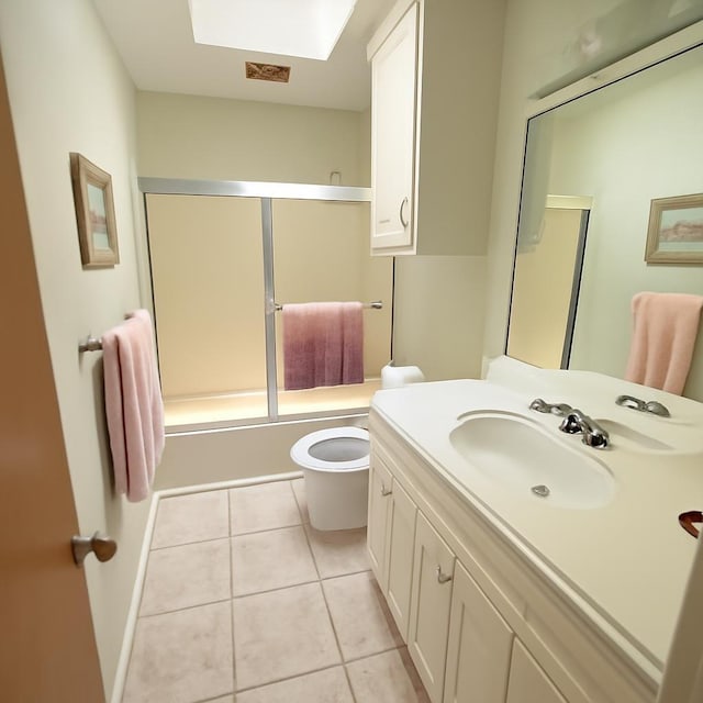 3185 Sea Castle Dr, Crystal Beach, TX 77650 - full bath featuring a skylight, vanity, combined bath / shower with glass door, and tile patterned flooring