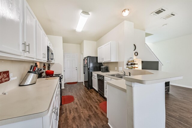 6103 Yorkglen Manor Ln, Houston, TX 77084 - kitchen with a peninsula, dark wood finished floors, black appliances, white cabinetry, and light countertops
