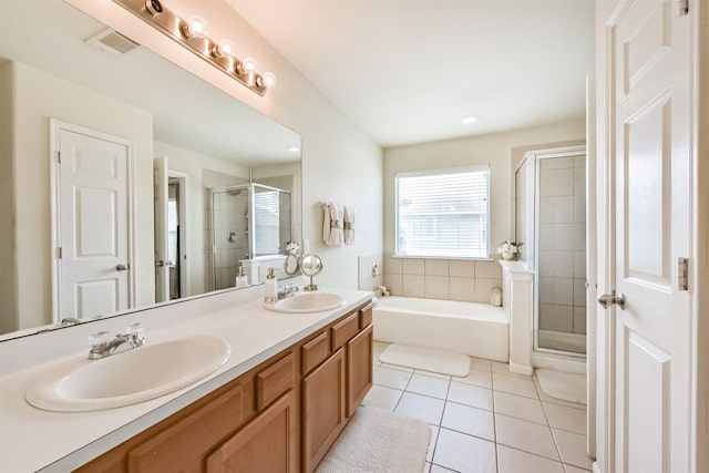 6103 Yorkglen Manor Ln, Houston, TX 77084 - bathroom with a stall shower, a garden tub, double vanity, tile patterned floors, and recessed lighting