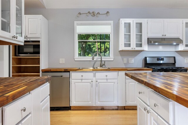 420 Hale St, Lexington, TX 78947 - kitchen featuring wooden counters, appliances with stainless steel finishes, exhaust hood, and white cabinets
