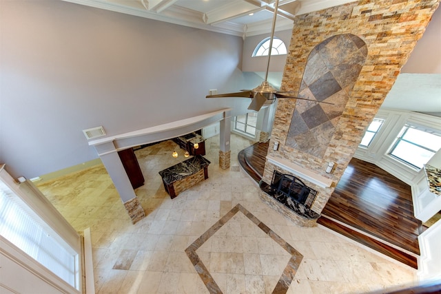 6803 Fawncliff Dr, Houston, TX 77069 - living room with a ceiling fan, crown molding, a stone fireplace, beam ceiling, and coffered ceiling