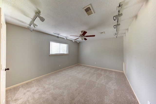 6803 Fawncliff Dr, Houston, TX 77069 - empty room with rail lighting, light carpet, ceiling fan, and a textured ceiling
