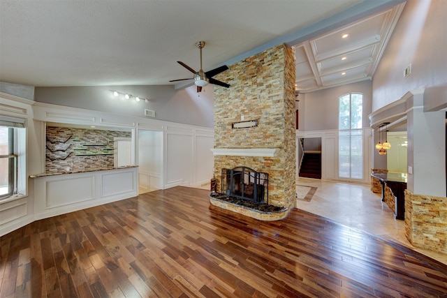 6803 Fawncliff Dr, Houston, TX 77069 - unfurnished living room featuring a decorative wall, hardwood / wood-style flooring, a fireplace, healthy amount of natural light, and a ceiling fan