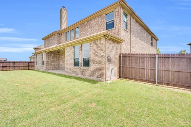 1708 Stillwater Dr, Burleson, TX 76028 - rear view of house featuring a chimney, brick siding, and a fenced backyard
