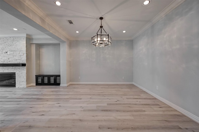 13619 Teal Bluff Ln, Houston, TX 77077 - unfurnished dining area with recessed lighting, wood finished floors, a chandelier, ornamental molding, and a stone fireplace