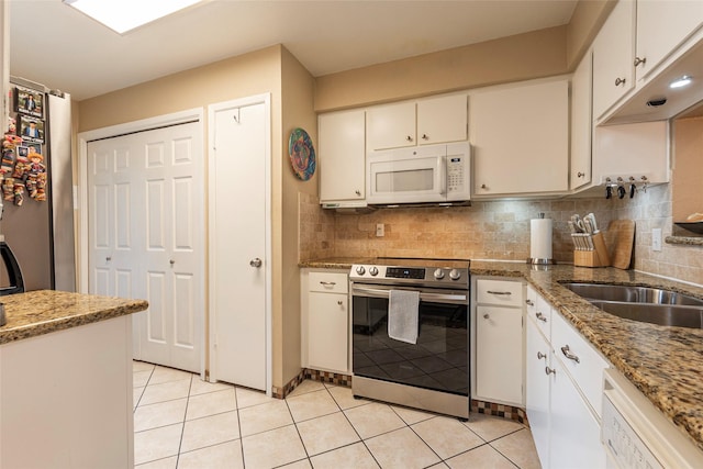 18800 Egret Bay Blvd Unit 1405, Webster, TX 77058 - kitchen with white appliances, tasteful backsplash, light tile patterned floors, and white cabinetry