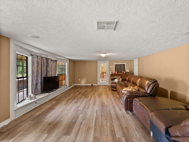 19995 Fm 92 S, Fred, TX 77616 - living room featuring wood finished floors and a textured ceiling