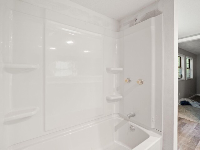 19995 Fm 92 S, Fred, TX 77616 - bathroom featuring wood finished floors and bathing tub / shower combination