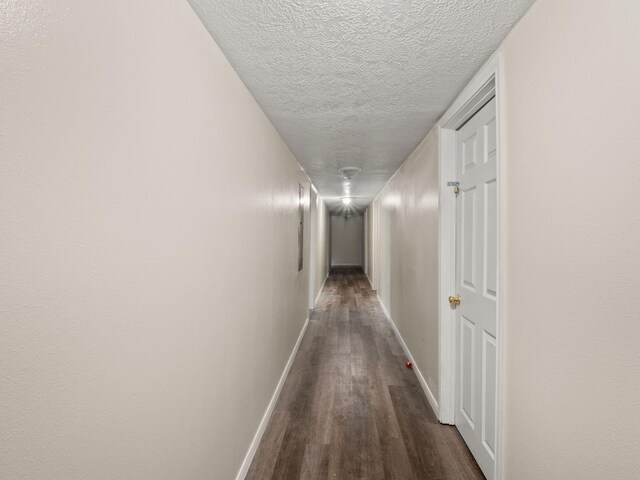 19995 Fm 92 S, Fred, TX 77616 - hallway featuring dark wood-style flooring and a textured ceiling