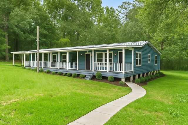 19995 Fm 92 S, Fred, TX 77616 - view of front of house with covered porch, a front yard, and a metal roof