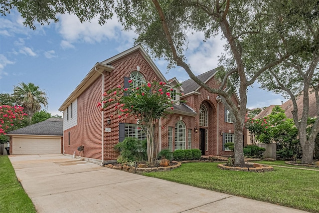 9 Foxworth Ct, Sugar Land, TX 77479 - view of front facade with brick siding, concrete driveway, a garage, and a front lawn