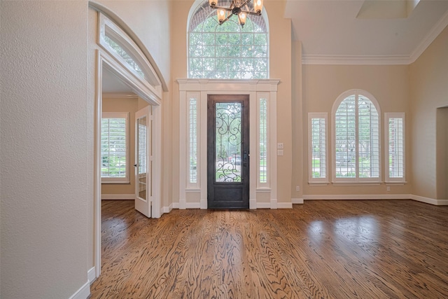 9 Foxworth Ct, Sugar Land, TX 77479 - entryway with wood finished floors, ornamental molding, and a chandelier