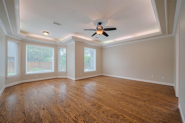 9 Foxworth Ct, Sugar Land, TX 77479 - unfurnished room with healthy amount of natural light, a tray ceiling, ceiling fan, crown molding, and wood finished floors