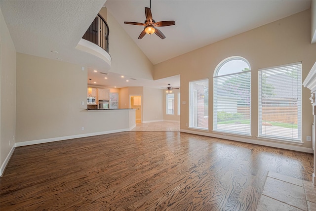 9 Foxworth Ct, Sugar Land, TX 77479 - unfurnished living room featuring ceiling fan, light wood-style floors, and high vaulted ceiling