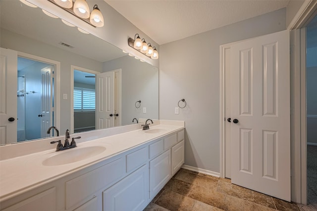 9 Foxworth Ct, Sugar Land, TX 77479 - full bath with double vanity and stone finish floors