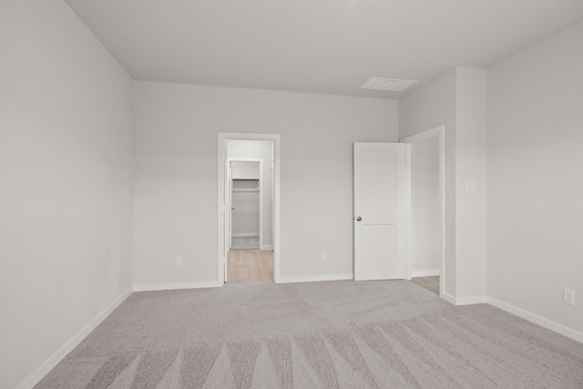 7826 Ruthie Ravine Ct, Spring, TX 77379 - unfurnished bedroom featuring carpet flooring and a walk in closet