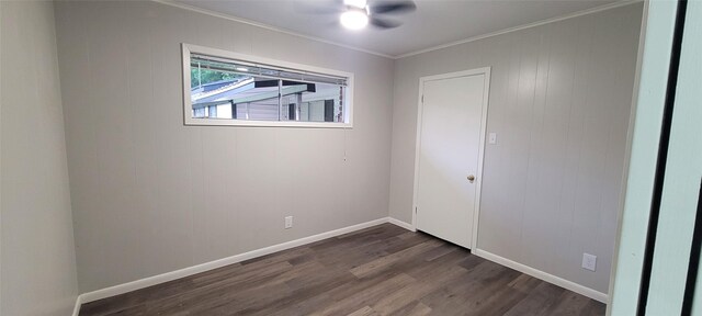 413 S Temple Dr, Diboll, TX 75941 - spare room featuring crown molding, dark wood-style flooring, and ceiling fan
